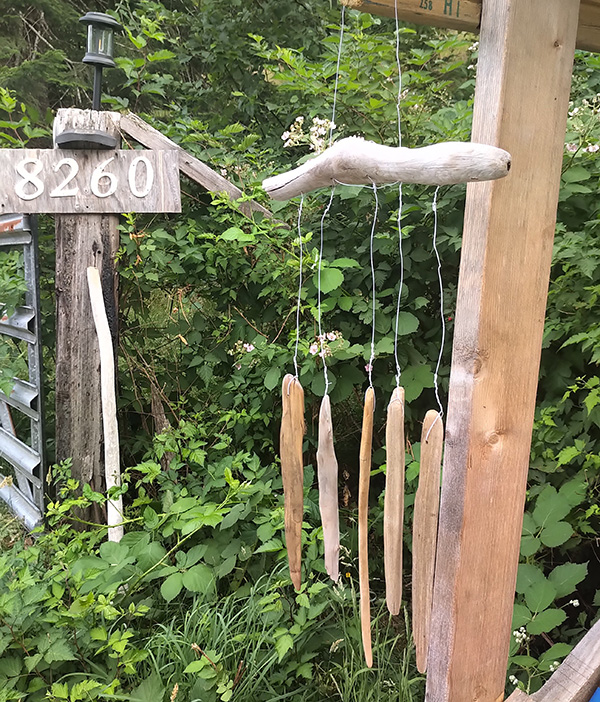 Driftwood mobile hanging at farm stand.